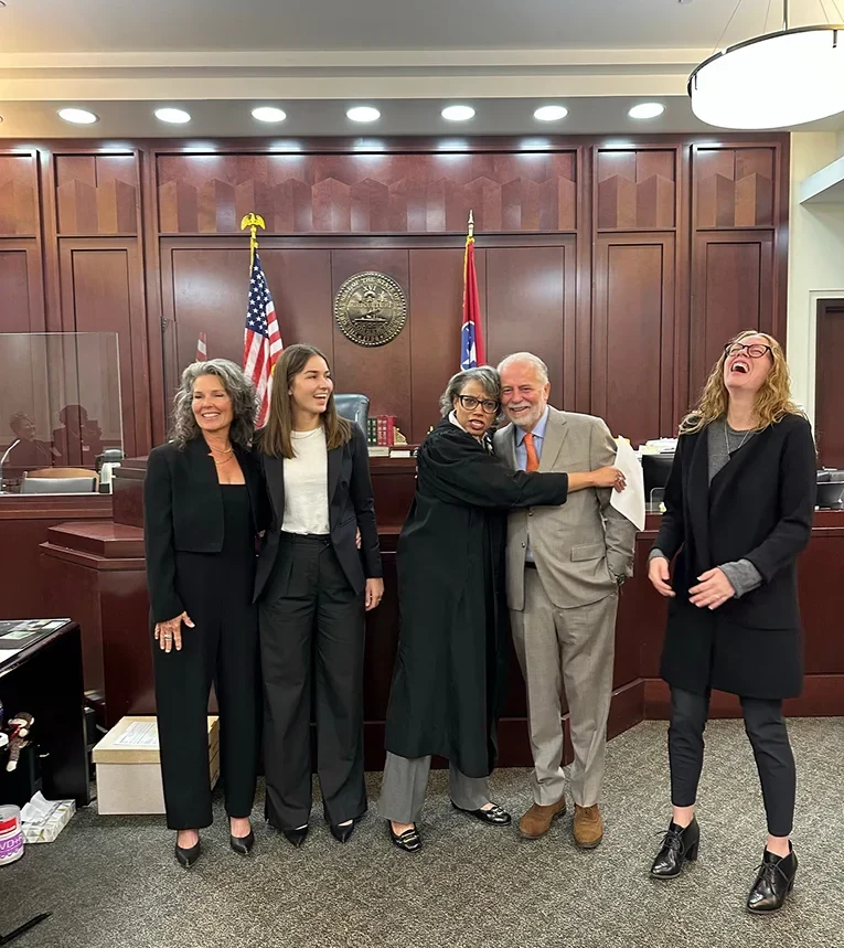 May McKinney attorneys and a judge sharing a lighthearted moment in a courtroom