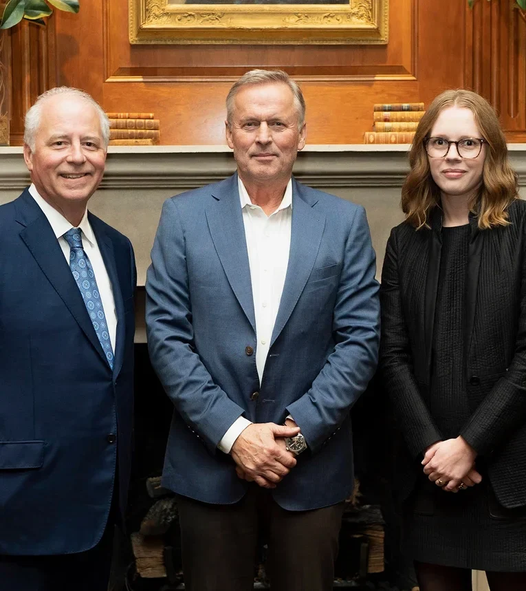 Rob McKinney and Shyanne Riddle with a guest at a professional legal event