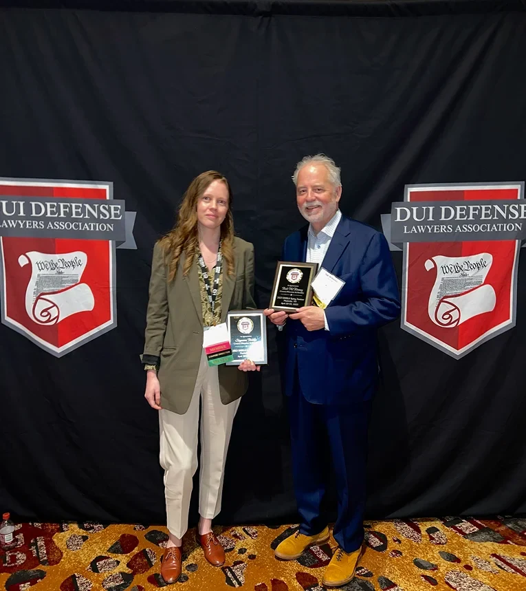 Shyanne Riddle receiving recognition alongside Rob McKinney at the DUI Defense Lawyers Association conference